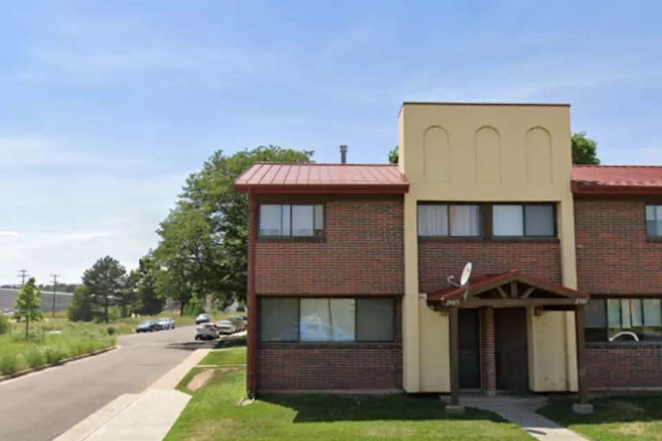 Google street view of two-story brick and stucco apartment building in Sun Valley neighborhood of Denver, Colorado.
